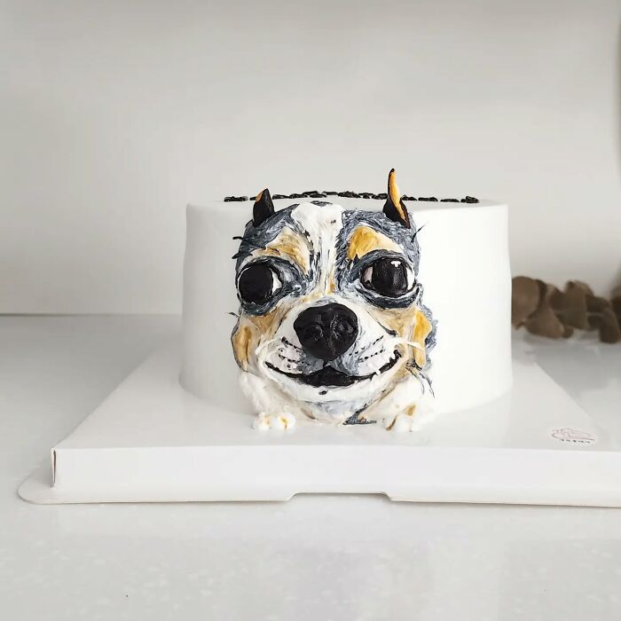 Pet-themed cake featuring a detailed dog face design that captures the unique personality with adorable artistic decoration.