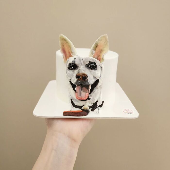 Pet-themed cake featuring a realistic happy dog face with detailed ears and tongue, showcasing unique personality art.