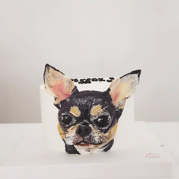 Pet-themed cake featuring a detailed and adorable 3D dog face capturing personality in edible art form.