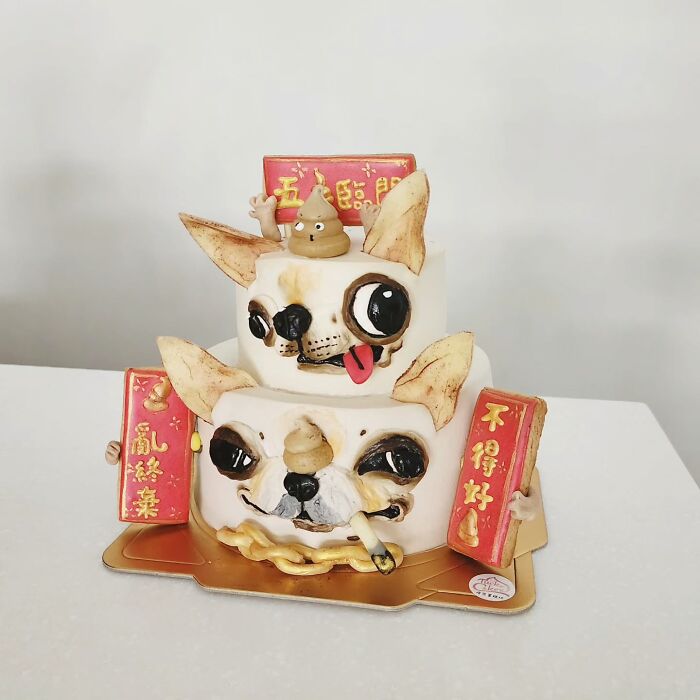 Pet-themed cake featuring two dog faces with playful expressions and decorative red plaques capturing unique personality.