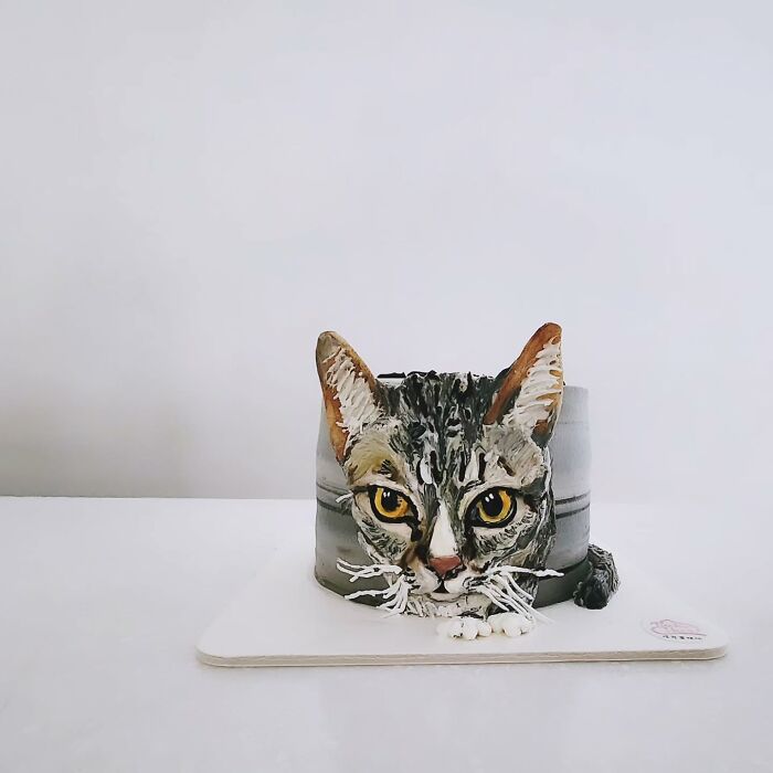 Pet-themed cake shaped and decorated as a realistic cat, showcasing adorable and unique artistic cake design.