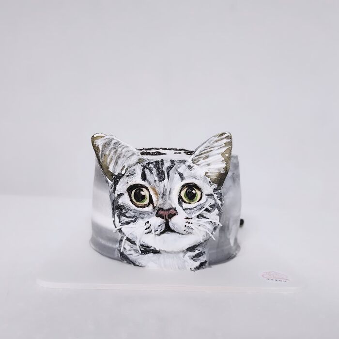 Adorable pet-themed cake shaped like a realistic cat head capturing the unique personality of the animal.