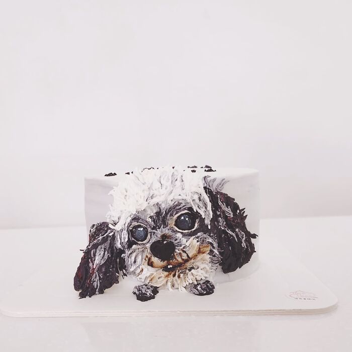 Pet-themed cake featuring a detailed and adorable dog design capturing unique personality with artistic icing techniques.