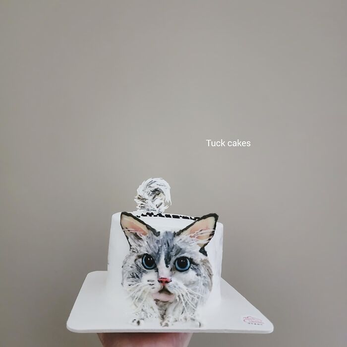 Pet-themed cake featuring a detailed, adorable cat portrait capturing the unique personality of the pet.