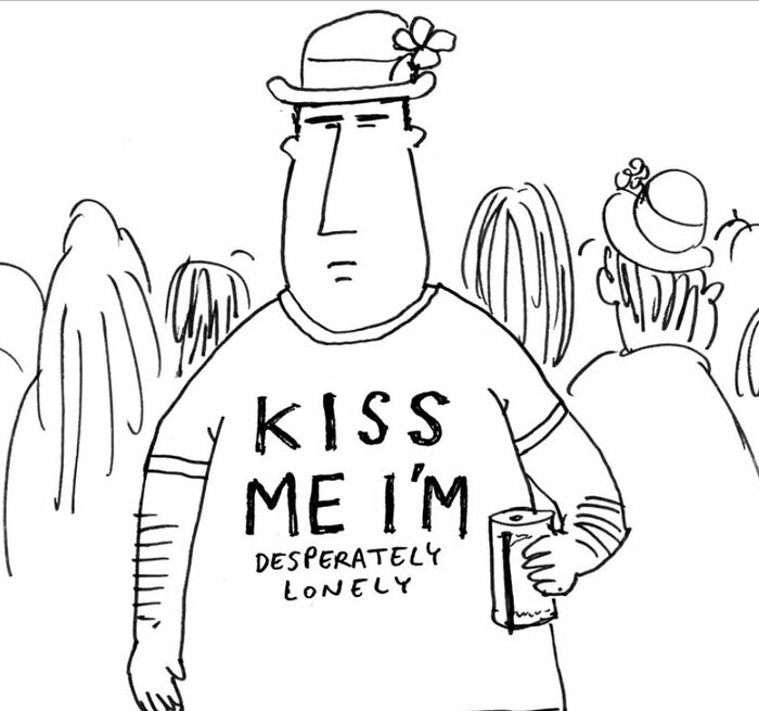 Man wearing a witty cartoon shirt saying kiss me I'm desperately lonely in a crowd, humor by Joe Dator.