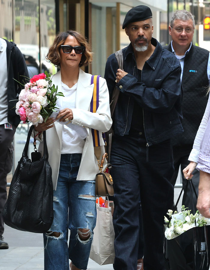 Halle Berry and her boyfriend walking on city street during public outing after proposal after five years of dating.