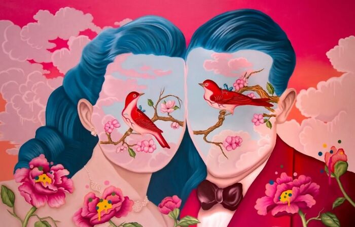 Surreal painting of a couple with blue hair and vivid dreamlike faces featuring red birds on flowering branches.