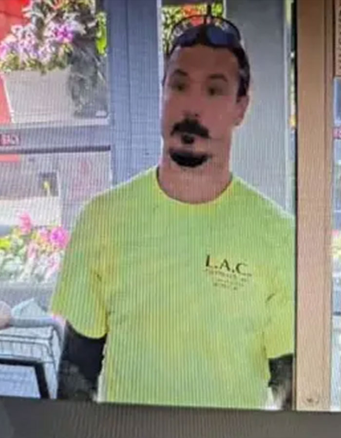 Man in a yellow shirt standing indoors near a window, related to tragic news about sisters suffocated by dad in the woods.