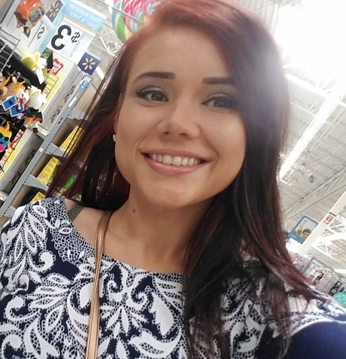 Whitney Purvis smiling in a store aisle, known 16 and Pregnant star mourning loss of her 16-year-old son.