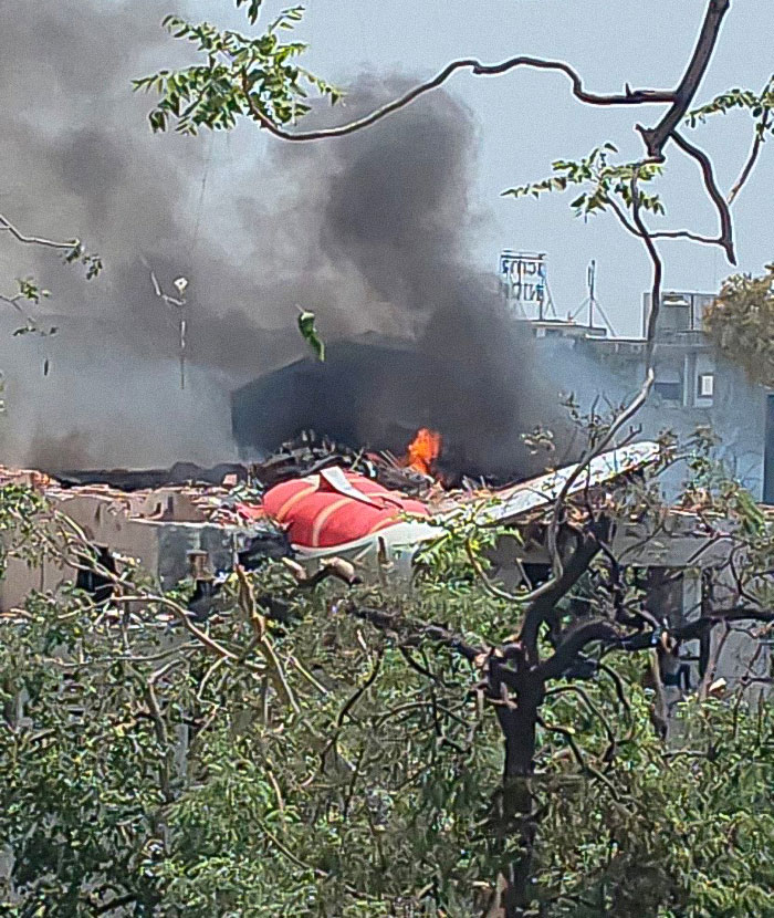 Wreckage of Air India Boeing jet with flames and smoke rising, highlighting tech failures before the crash.