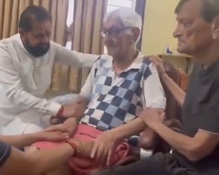 Elderly Air India pilot supported by family members after being hailed a hero for saving hundreds in plane crash.