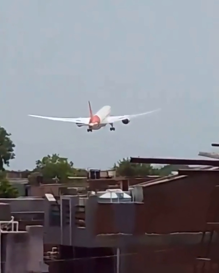 Air India plane landing near buildings, highlighting pilot heroism in saving hundreds of people during tragic crash.