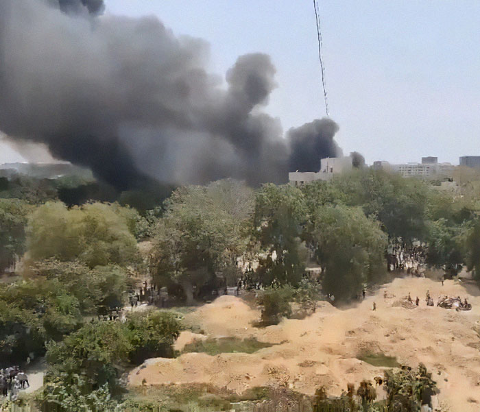 Thick black smoke rising over trees and buildings after Air India plane disaster moment captured by family.