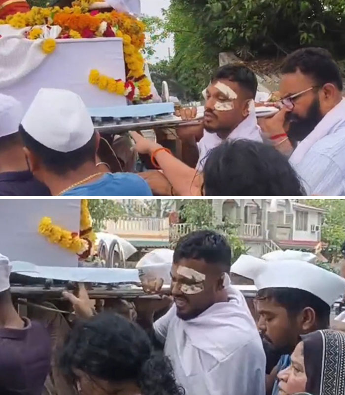 Man with bandages on face carrying decorated coffin during Air India survivor's funeral procession expressing survivor's guilt.