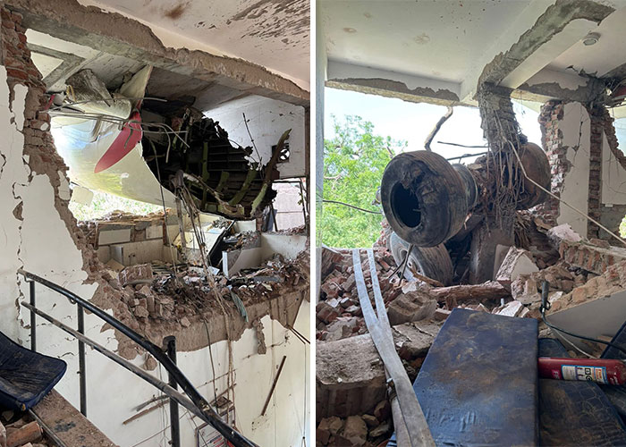Damaged Air India plane wreckage inside a building, highlighting the aftermath experienced by survivors with survivor's guilt.