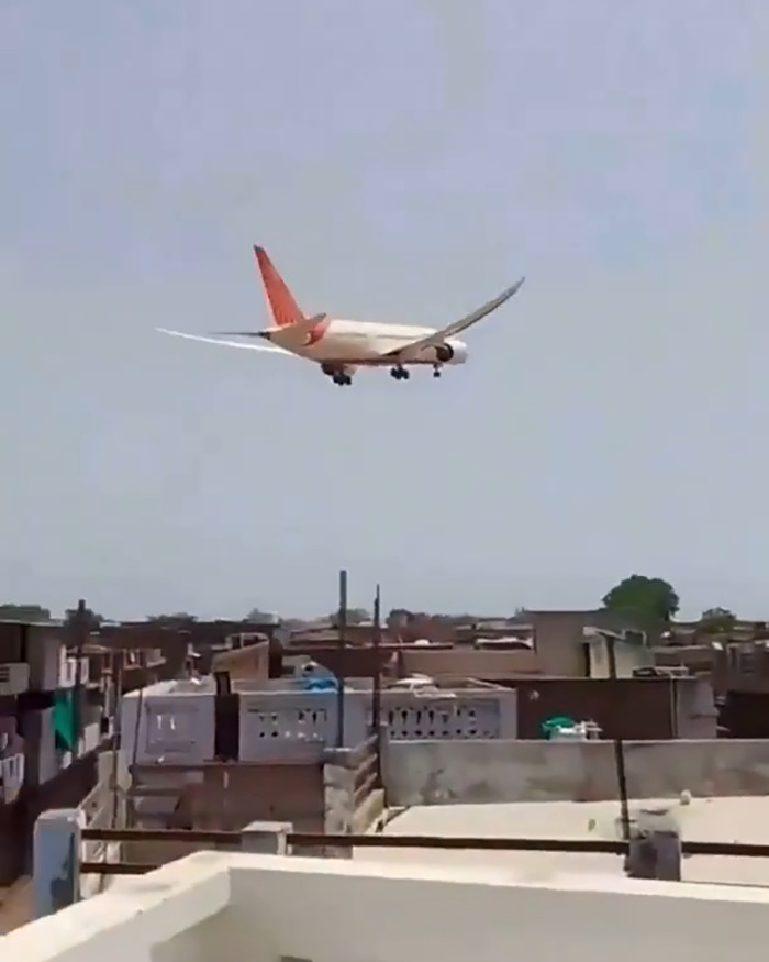 Air India plane flying low over residential area, linked to sole survivor of Air India crash story.