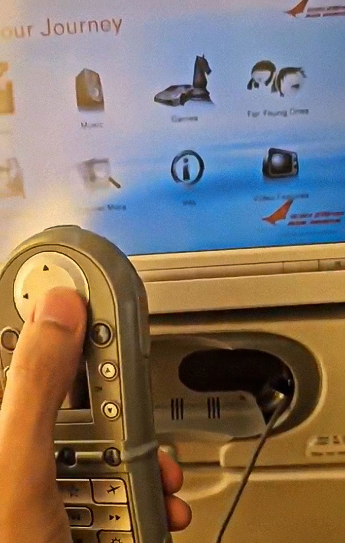 Passenger using in-flight entertainment remote on Air India Boeing jet revealing tech issues before crash.