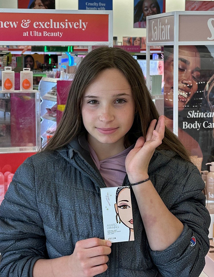 Teen girl found alive after missing for six weeks, standing in a beauty store holding a skincare product confidently. Teen girl found alive after missing for six weeks, standing in a beauty store holding a skincare product confidently.