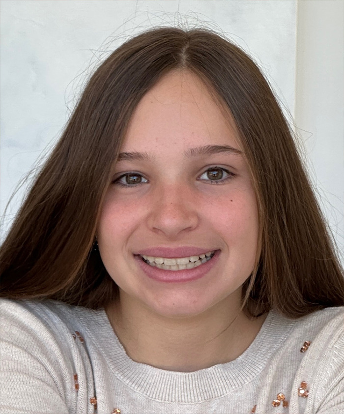 Smiling teenage girl with long brown hair wearing a light sweater, representing missing 15YO girl found alive news story. Smiling teenage girl with long brown hair wearing a light sweater, representing missing 15YO girl found alive news story.