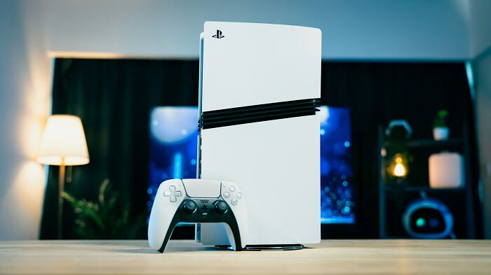 White PlayStation 5 console with controller on table, highlighting sneaky things found by people reading terms and conditions.