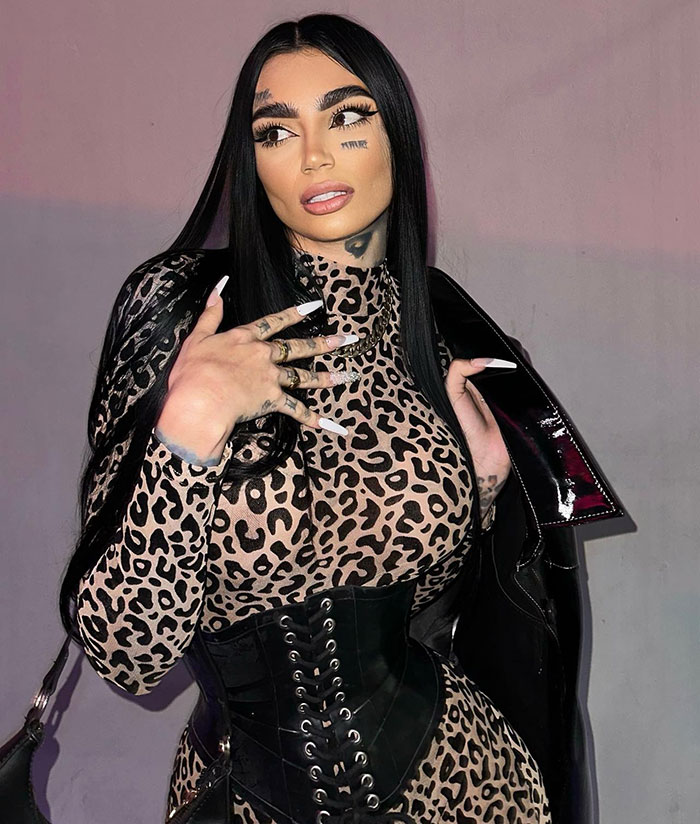 Woman in leopard print outfit and corset posing dramatically, illustrating plastic surgery and singer party tragedy themes.