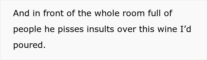 Person pouring wine for a friend while receiving insults in front of a room full of people during a wine sample.