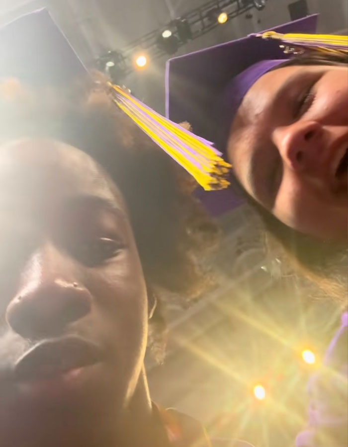 Two Florida high school grads in purple caps with yellow tassels during a viral stage mishap graduation moment.