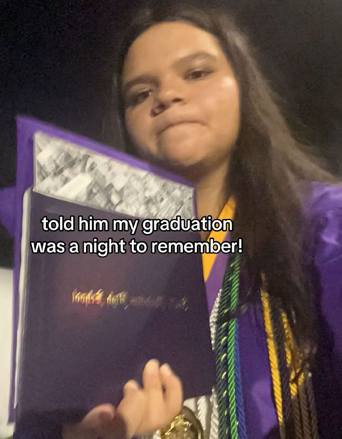 Female Florida high school grad wearing cap and gown holding diploma after viral stage crash mishap at graduation ceremony.