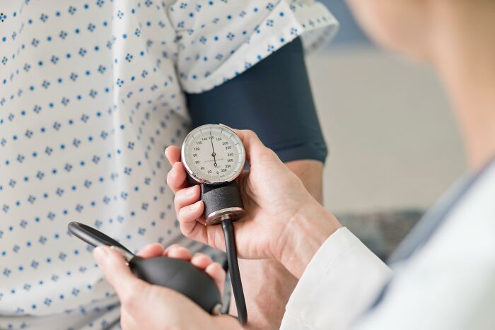 Medical professional measuring blood pressure of a patient.