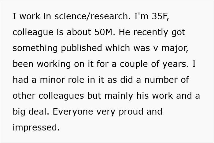 Female scientist smiling and handing a small potted plant to male colleague in a research lab setting.