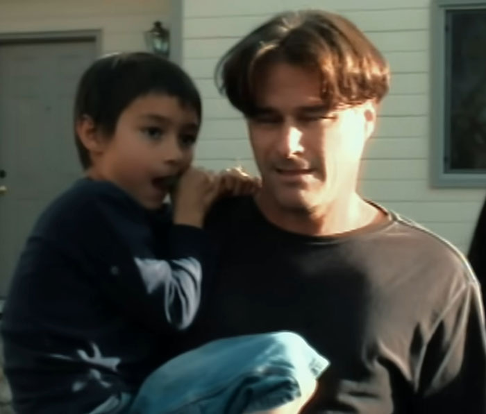 Man holding young boy outside a house, related to Balloon Boy family controversy from 16 years ago.