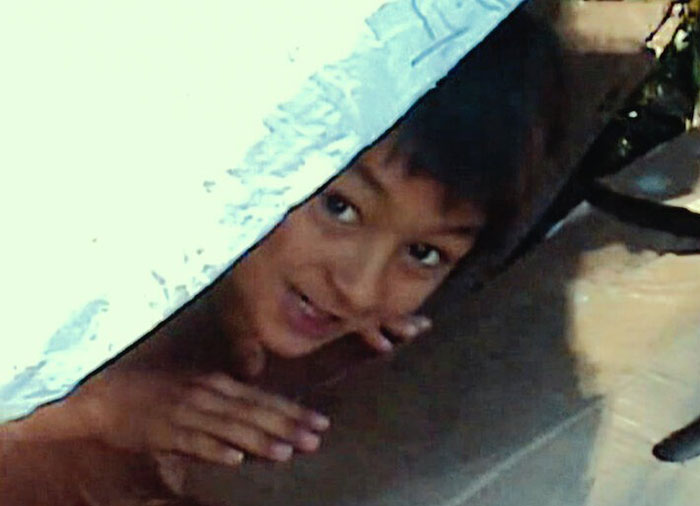 Child peeking from under a fabric, related to the Balloon Boy family and infamous controversy discussed years later.