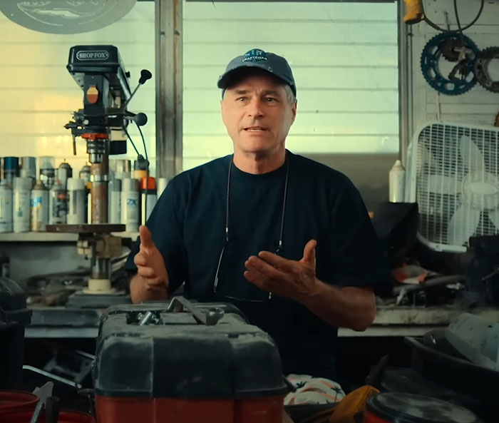Man in a workshop explaining the Balloon Boy family controversy, surrounded by tools and machinery.