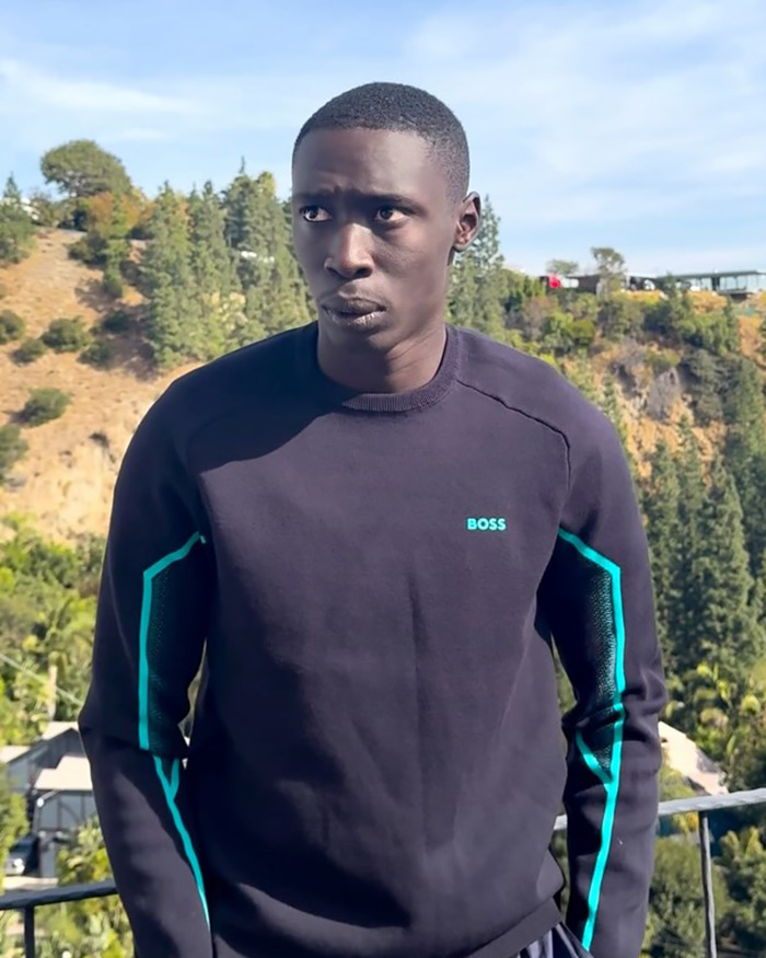 Khaby Lame outdoors with trees and hills in the background, related to ICE detention and illegal alien claims. Khaby Lame outdoors with trees and hills in the background, related to ICE detention and illegal alien claims.