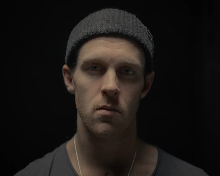 Young Jiu-Jitsu student wearing a gray beanie, looking solemn after a tragic freak accident in sparring incident.