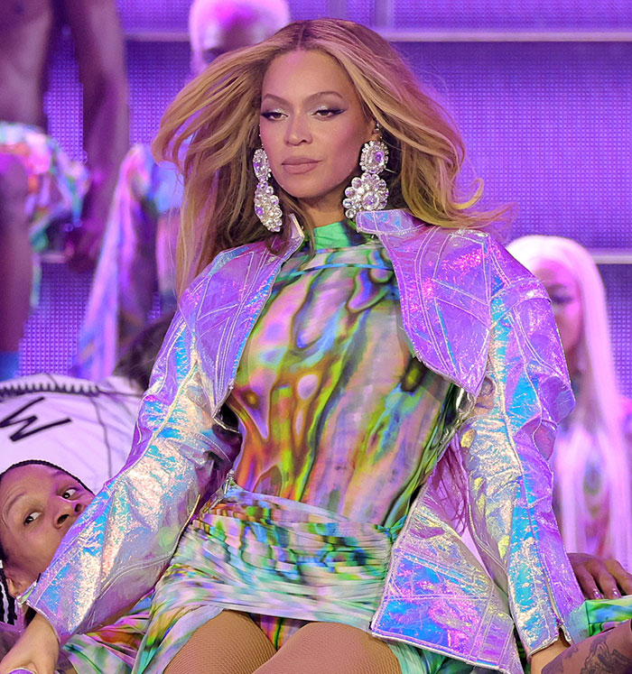 Beyonc&eacute; performing on stage wearing a colorful outfit amid controversy on Cowboy Carter Tour with tone deaf fan backlash.