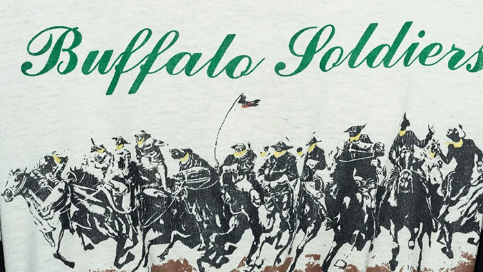 Buffalo Soldiers graphic on a white shirt worn during Cowboy Carter Tour, linked to Beyonc&eacute; tone deaf controversy.