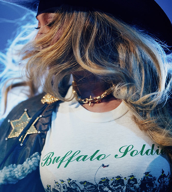 Beyonc&eacute; wearing a Buffalo Soldier shirt with cowboy hat and jacket during the Cowboy Carter Tour amid fan backlash.