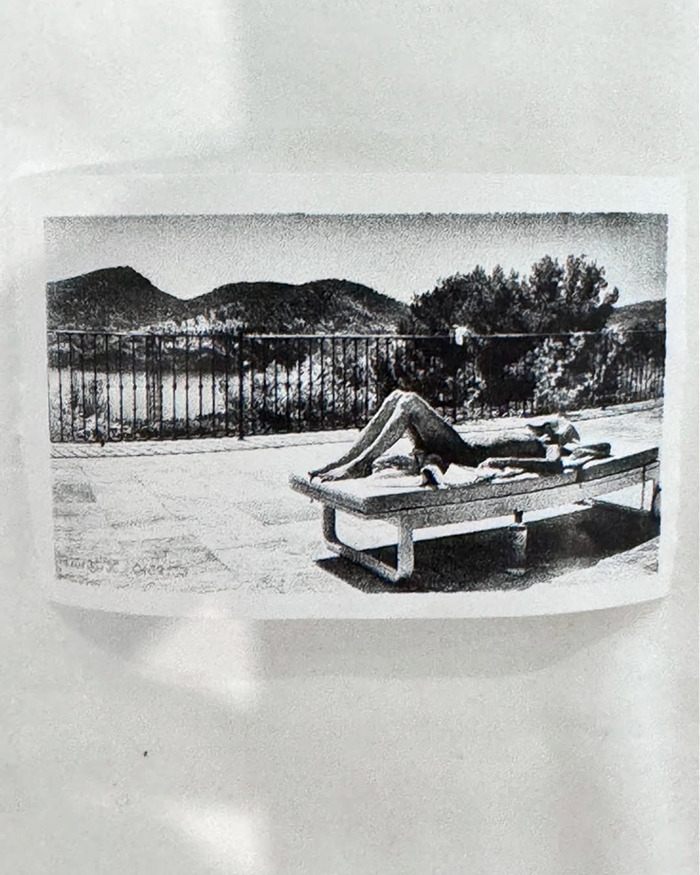 Black and white photo print of a person lying topless on a lounge chair with mountains in the background, linked to Kanye grooming fears.