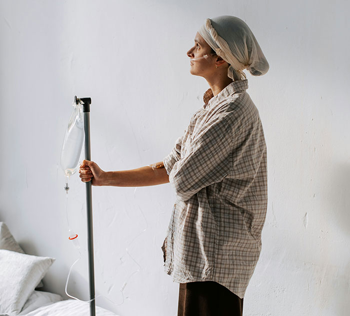 Young woman with an oxygen tube and IV drip, highlighting some of the biggest flaws of the human body related to health issues.