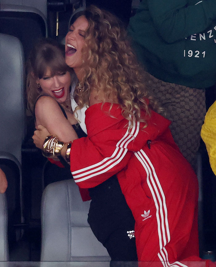 Taylor Swift and Blake Lively sharing a joyful moment with hugs and laughter at an event. Taylor Swift and Blake Lively sharing a joyful moment with hugs and laughter at an event.