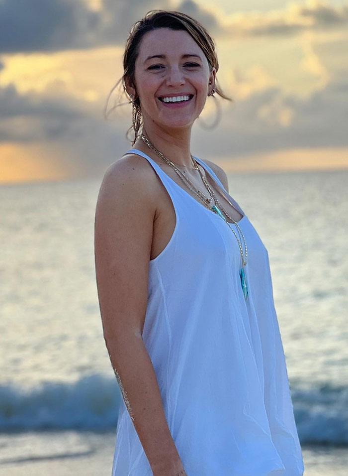 Woman in a white dress smiling by the beach at sunset, related to Taylor Swift ghosting Blake Lively rumors. Woman in a white dress smiling by the beach at sunset, related to Taylor Swift ghosting Blake Lively rumors.