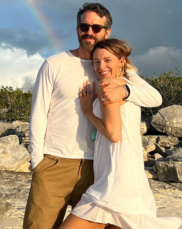 Man in sunglasses hugging woman in white dress outdoors, unrelated to Taylor Swift ghosting Blake Lively topics. Man in sunglasses hugging woman in white dress outdoors, unrelated to Taylor Swift ghosting Blake Lively topics.