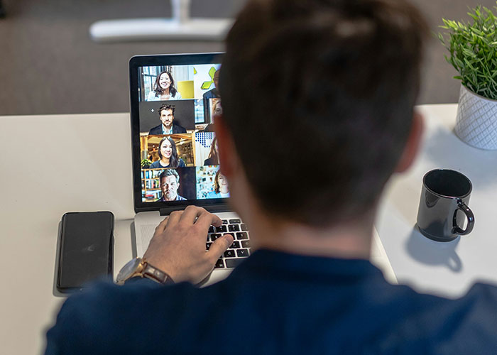 Person attending virtual meeting during lunch break, highlighting boss demands and work sacrifice regrets. Person attending virtual meeting during lunch break, highlighting boss demands and work sacrifice regrets.