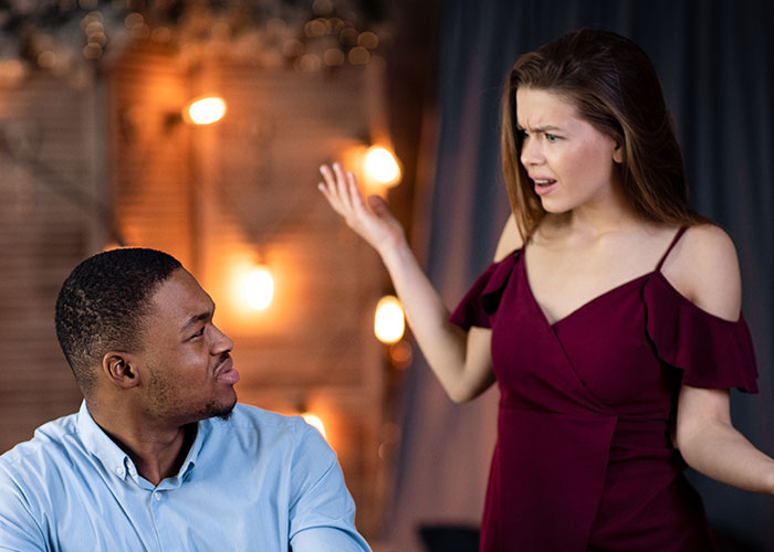 Woman refusing to leave party she planned, confronting boyfriend and his friends about privacy demands in tense moment.