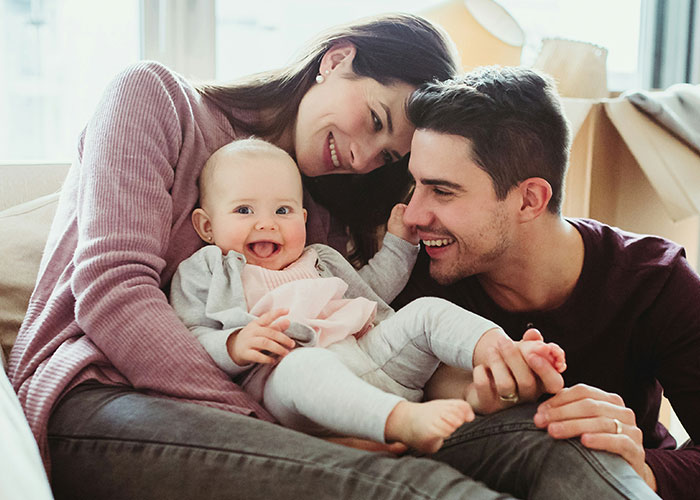 Happy family with baby sharing a joyful moment together, illustrating times people broke guy or girl code.