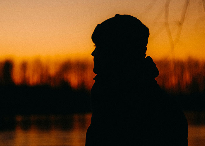 Silhouette of a person at sunset representing moments people broke guy or girl code for better choices in life.