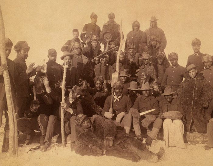 Vintage group photo of men in military uniforms with some in animal costumes, tone deaf controversy concept.