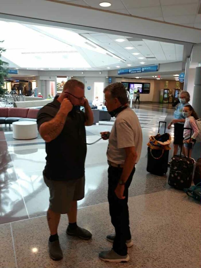 A dad listens to his late son&rsquo;s heartbeat inside a teddy bear while meeting the man who carries it today in an airport.