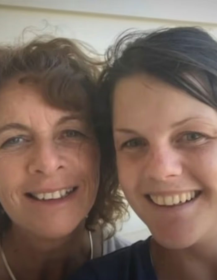 Two women smiling closely together in a casual setting, related to Australian woman caffeine consumption awareness.